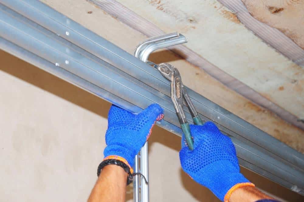 Professional fixes a garage door